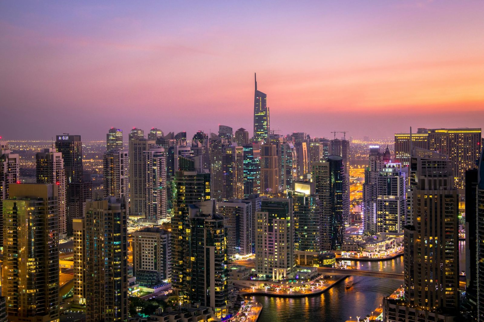 Sunset view of Dubai Marina skyline with modern skyscrapers and waterfront.
