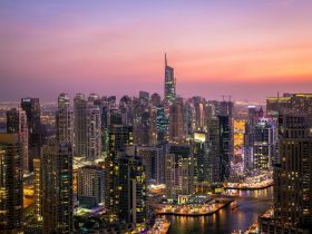 Sunset view of Dubai Marina skyline with modern skyscrapers and waterfront.