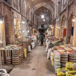 Interior view of Tabriz Grand Bazaar with people walking through arched corridors