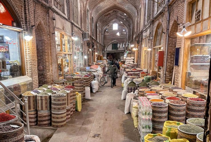 Interior view of Tabriz Grand Bazaar with people walking through arched corridors