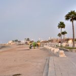 Beautiful coastal view of Al Khor, Qatar, with clear skies, calm waters, and boats near the shore, perfect for a travel blog header.