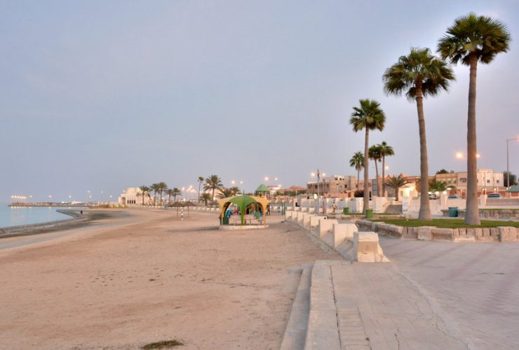 Beautiful coastal view of Al Khor, Qatar, with clear skies, calm waters, and boats near the shore, perfect for a travel blog header.