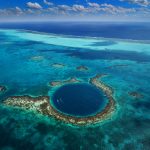 Blue Hole Belize - A breathtaking underwater sinkhole surrounded by crystal-clear waters and vibrant marine life.