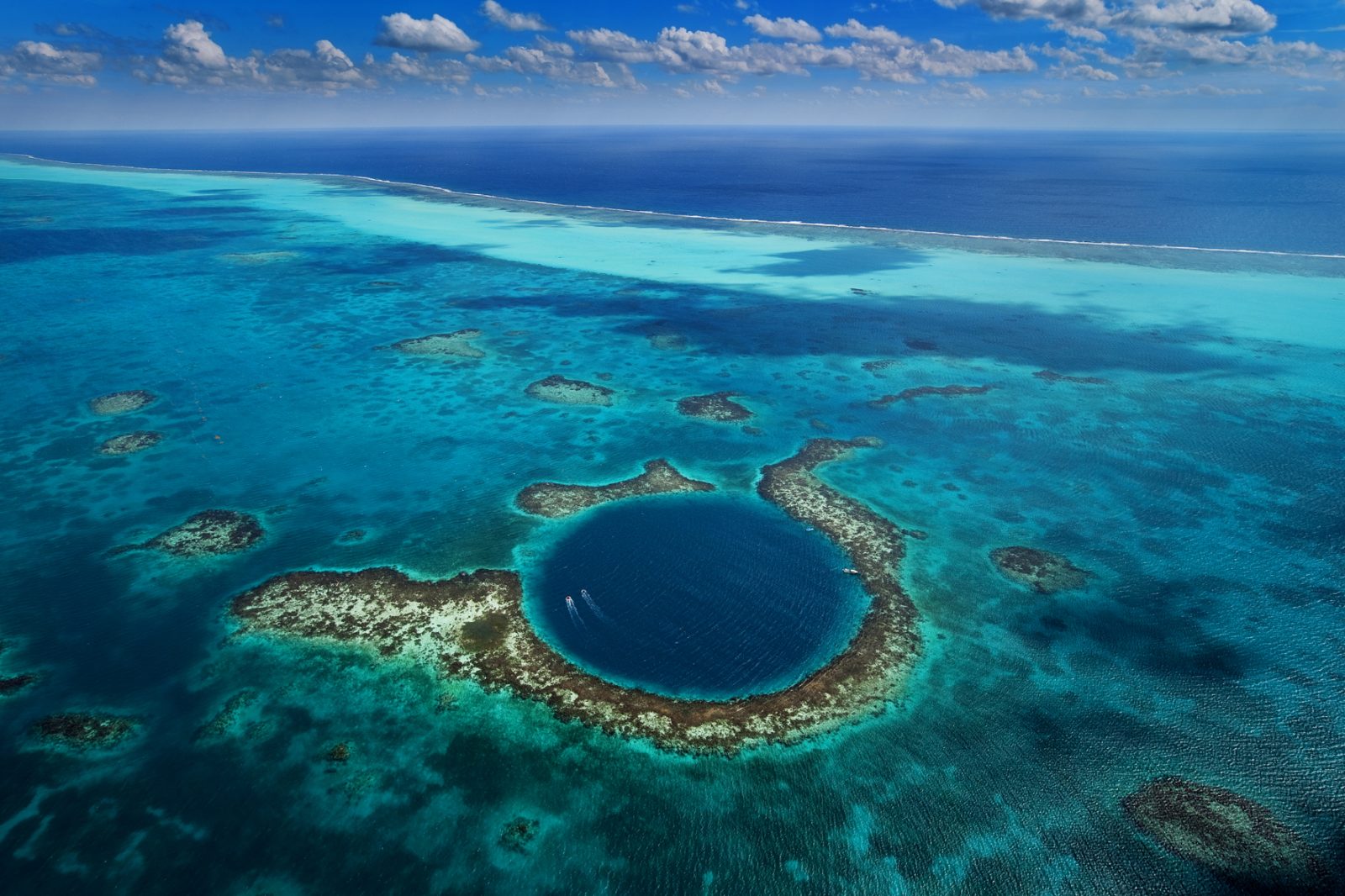 Blue Hole Belize - A breathtaking underwater sinkhole surrounded by crystal-clear waters and vibrant marine life.