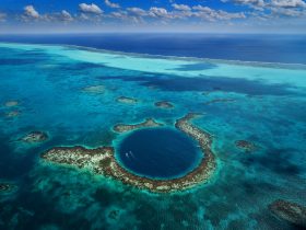 Blue Hole Belize - A breathtaking underwater sinkhole surrounded by crystal-clear waters and vibrant marine life.