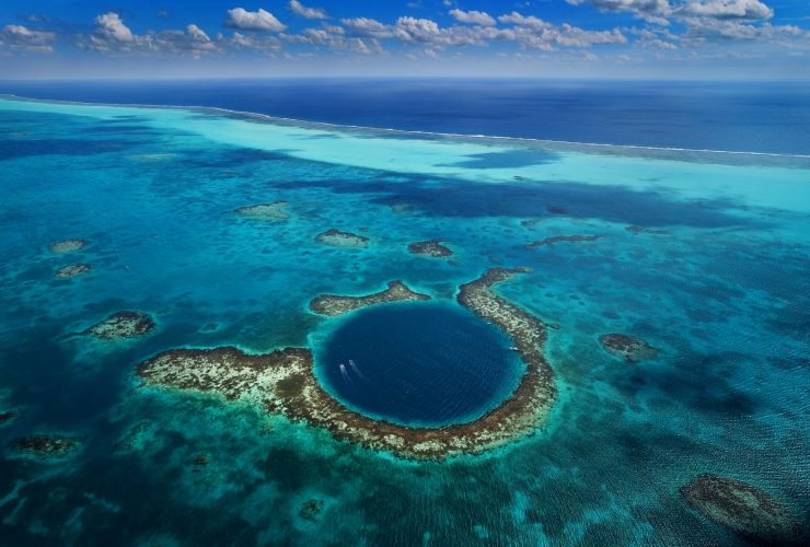 Blue Hole Belize - A breathtaking underwater sinkhole surrounded by crystal-clear waters and vibrant marine life.
