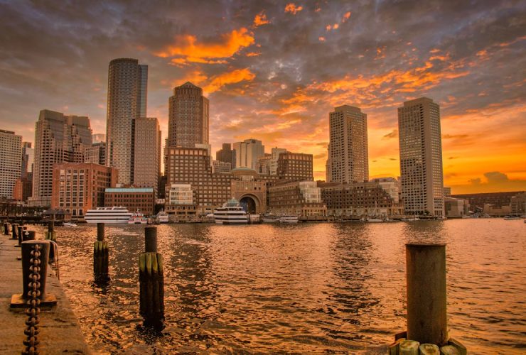 Boston skyline at sunset with reflections on the Charles River