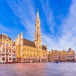Brussels Grand Place illuminated at night with historic guildhalls and cobbled square
