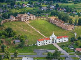 A scenic view of the Yaselda River with Byaroza Monastery ruins in the background, Belarus