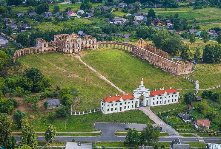 A scenic view of the Yaselda River with Byaroza Monastery ruins in the background, Belarus