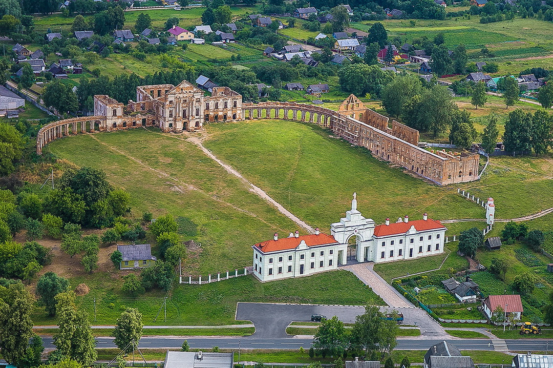 A scenic view of the Yaselda River with Byaroza Monastery ruins in the background, Belarus