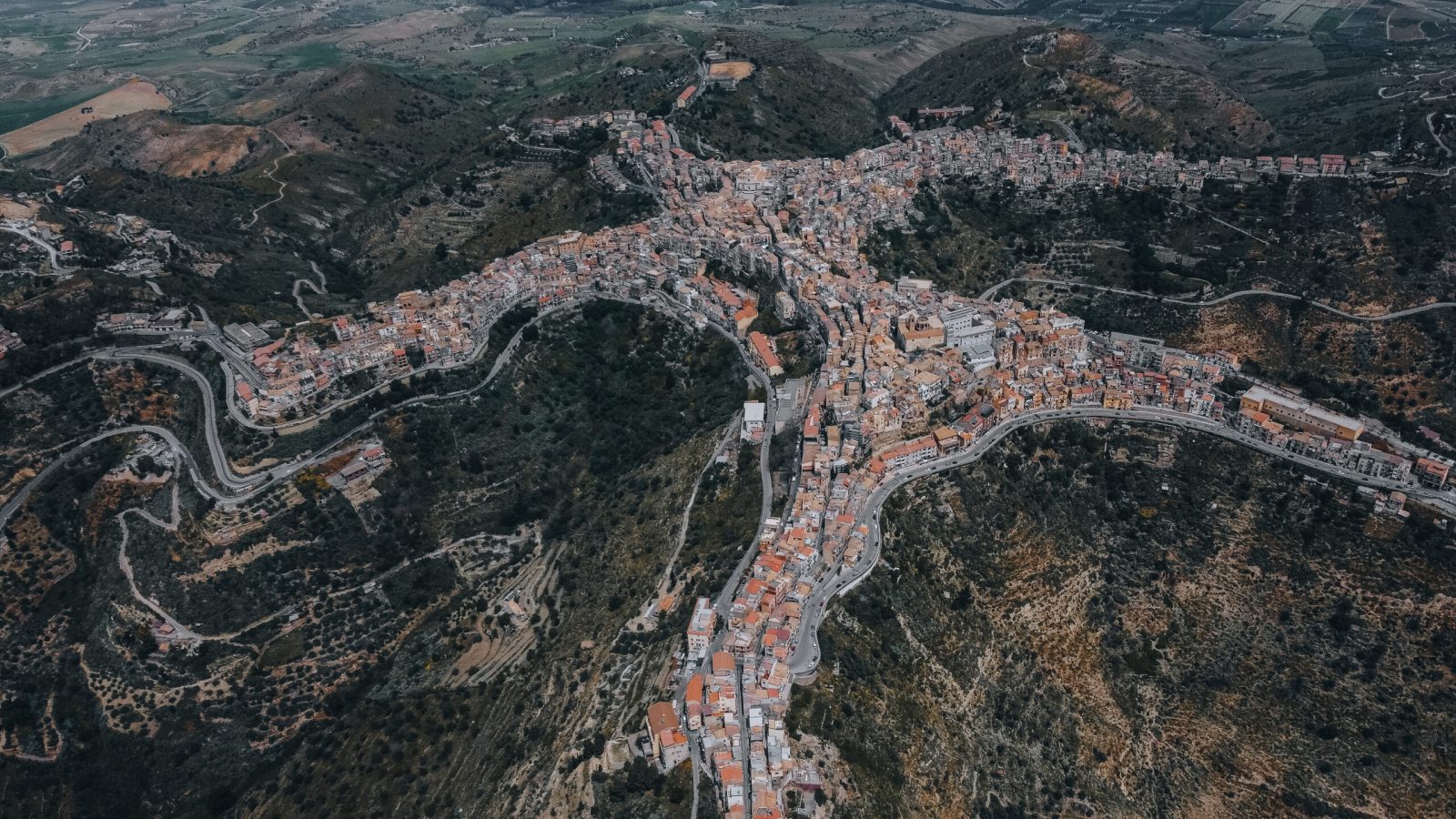 Panoramic view of Centuripe, Sicily, highlighting its distinctive hilltop layout and surrounding landscape.