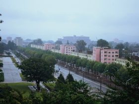 Hamhung cityscape with Mount Kuwol in the background, showcasing North Korea's unique blend of nature and urban life.