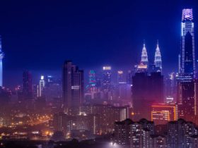 Kuala Lumpur skyline illuminated at night with Petronas Twin Towers and KL Tower