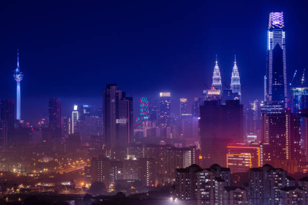Kuala Lumpur skyline illuminated at night with Petronas Twin Towers and KL Tower