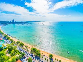 Aerial view of Pattaya city skyline with the beach and turquoise sea under a blue sky