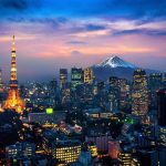 Tokyo skyline at dusk featuring Tokyo Tower and Mount Fuji in the background.