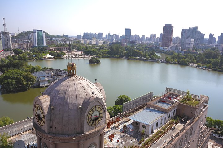 Wuhu city skyline with Yangtze River in the foreground, showcasing the city’s blend of modern and historical architecture.